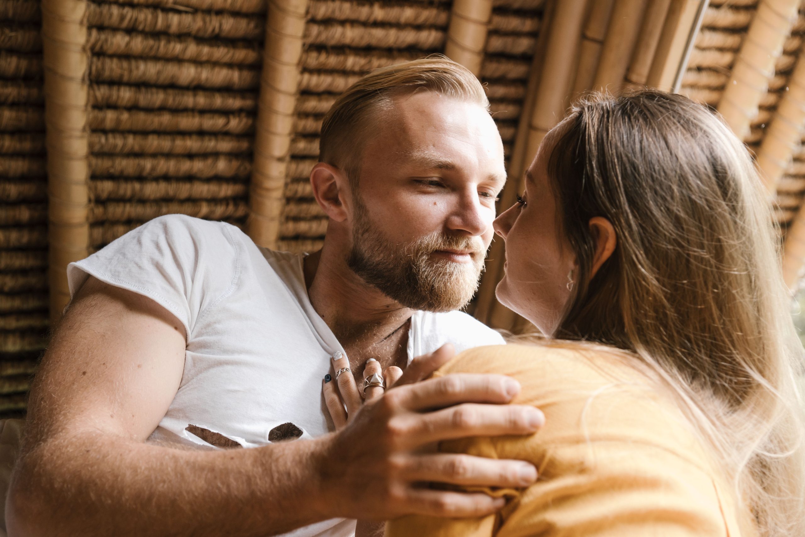 Couple affectionately looking into each other's eyes in a warm setting, the essence of being truly seen and emotionally present