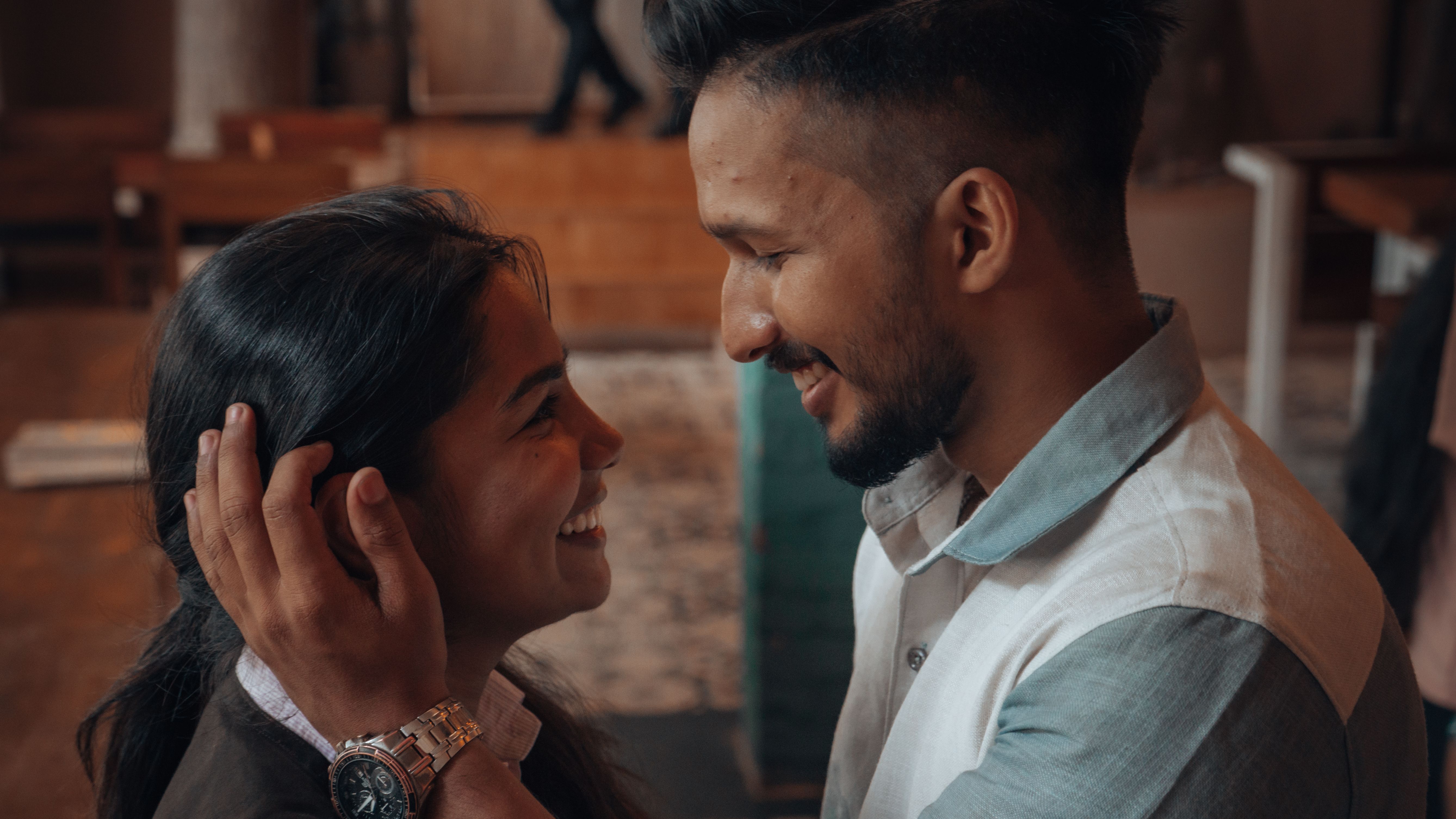 Couple sharing a tender moment in a cozy cafe atmosphere, focused fully on one another