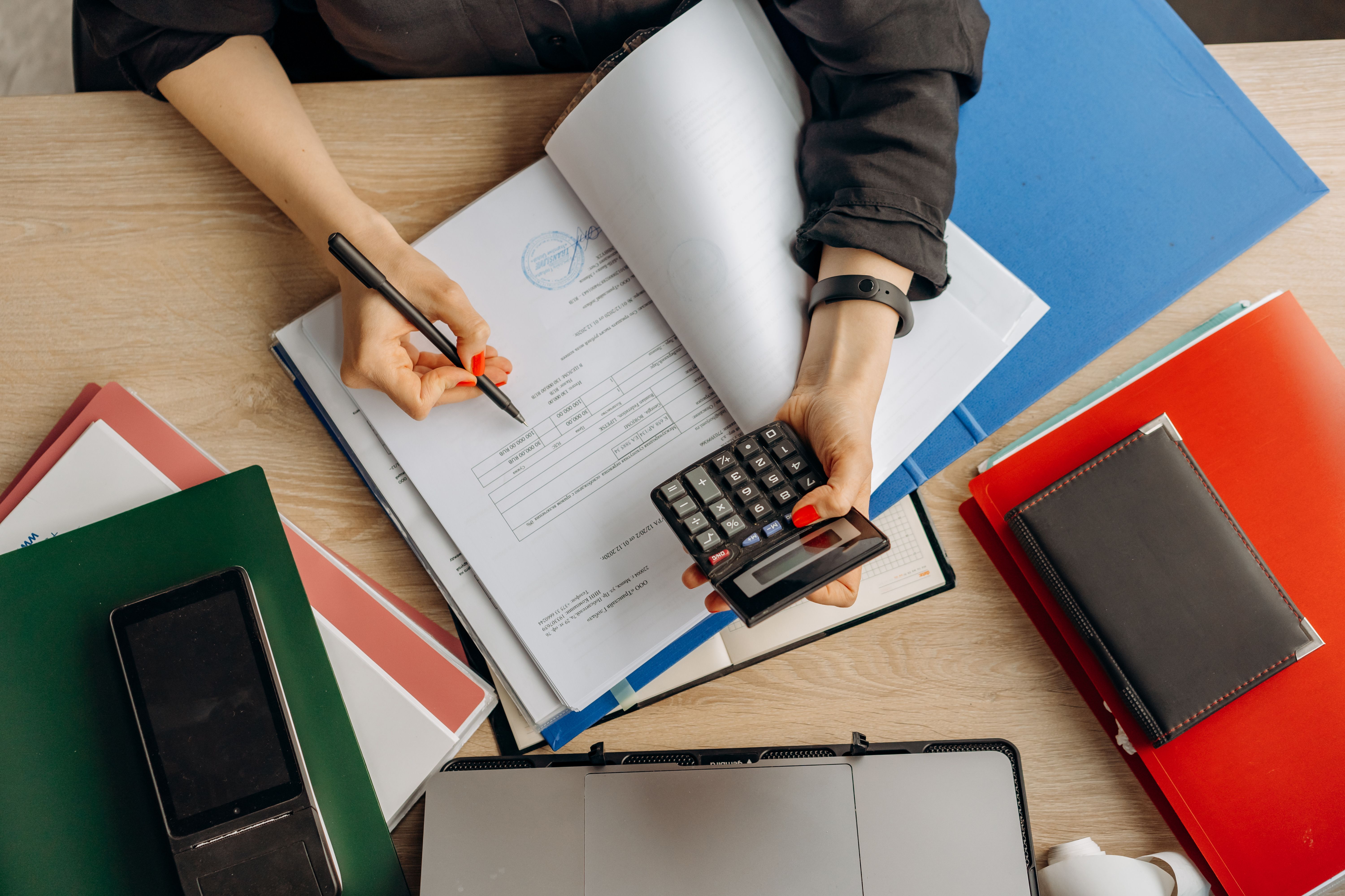 Accountant analyzing financial documents with a calculator on a desk