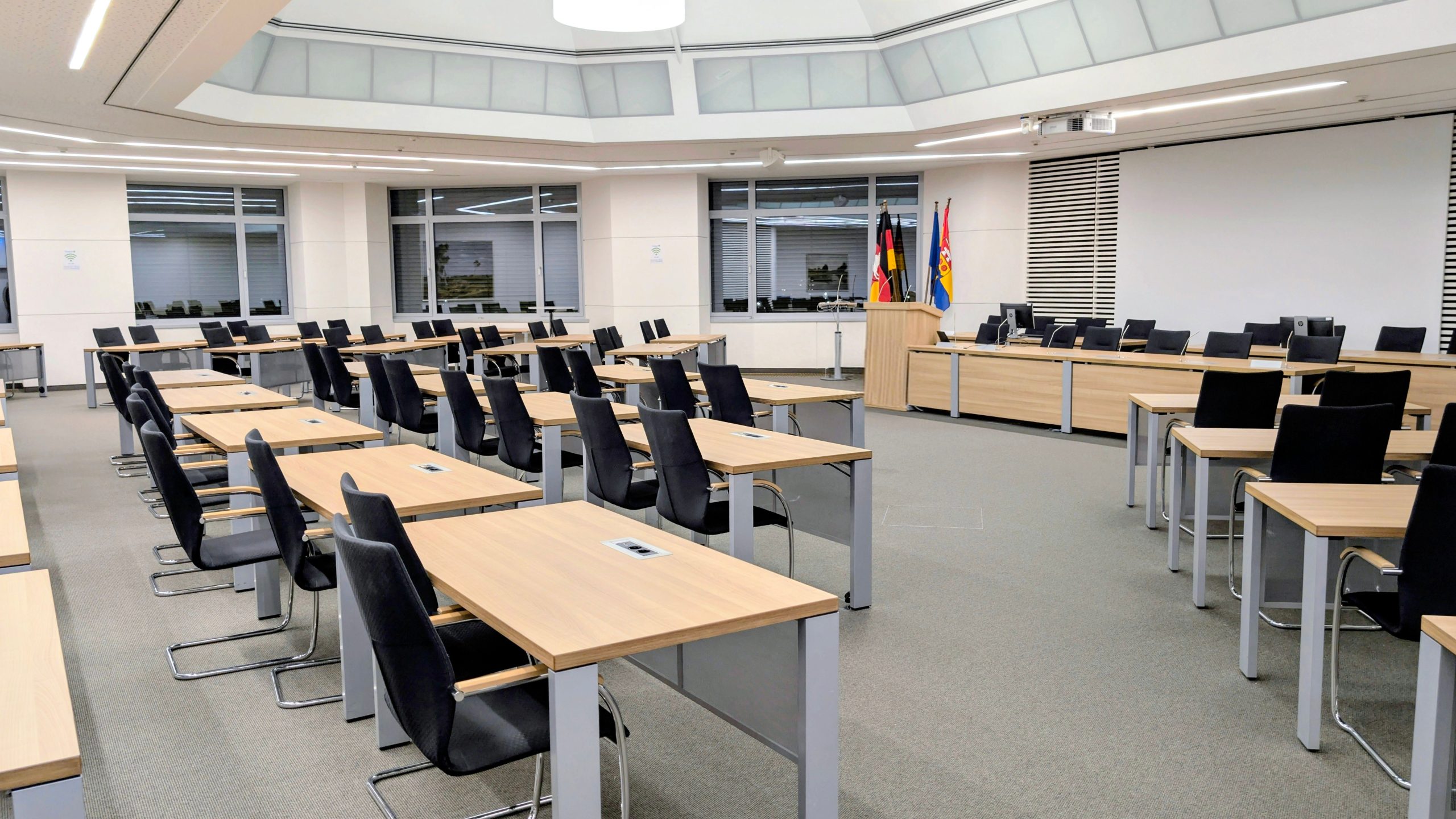 Government cabinet meeting room with desks and national flags