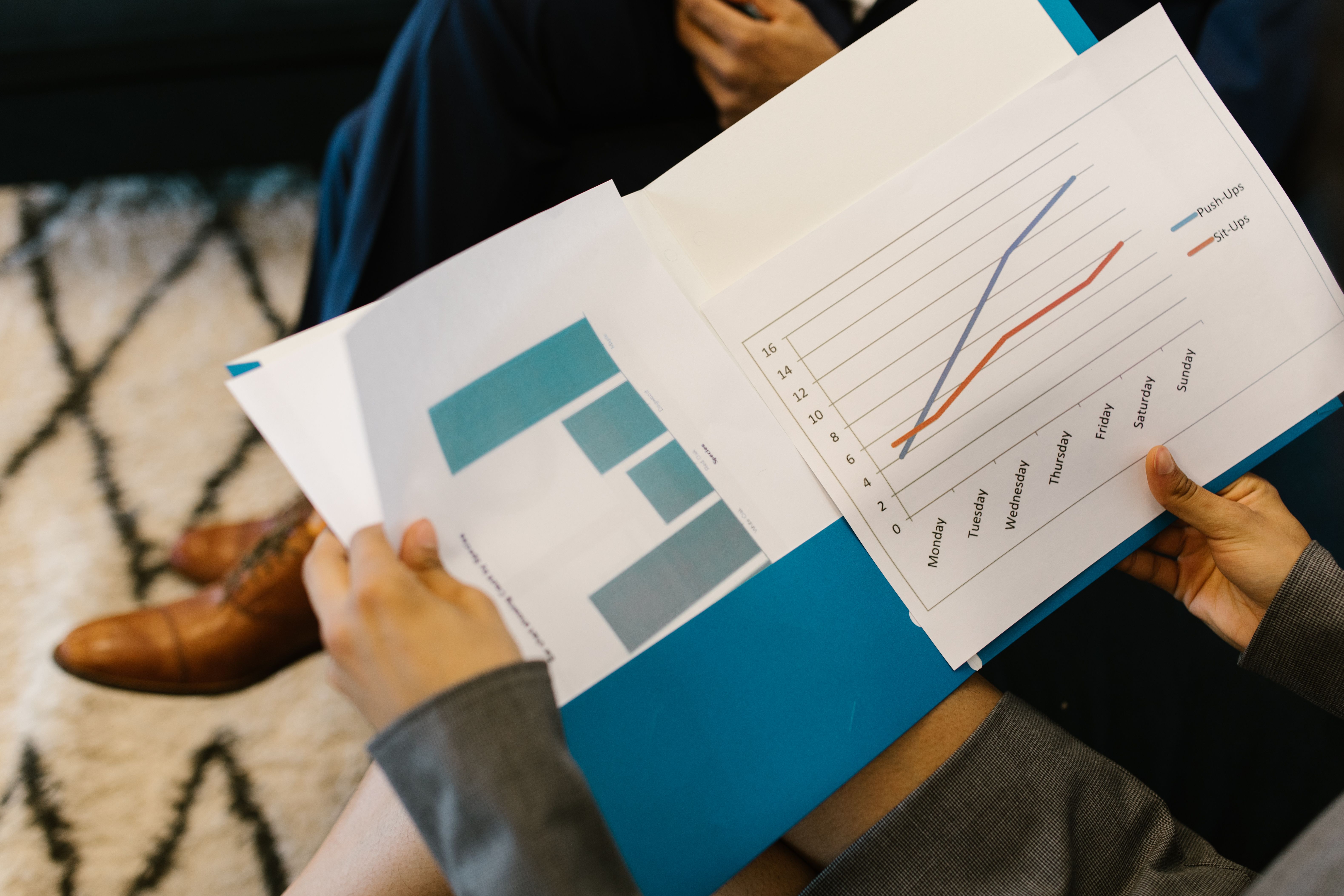 Detailed view of business reports with graphs during a law firm budget review meeting
