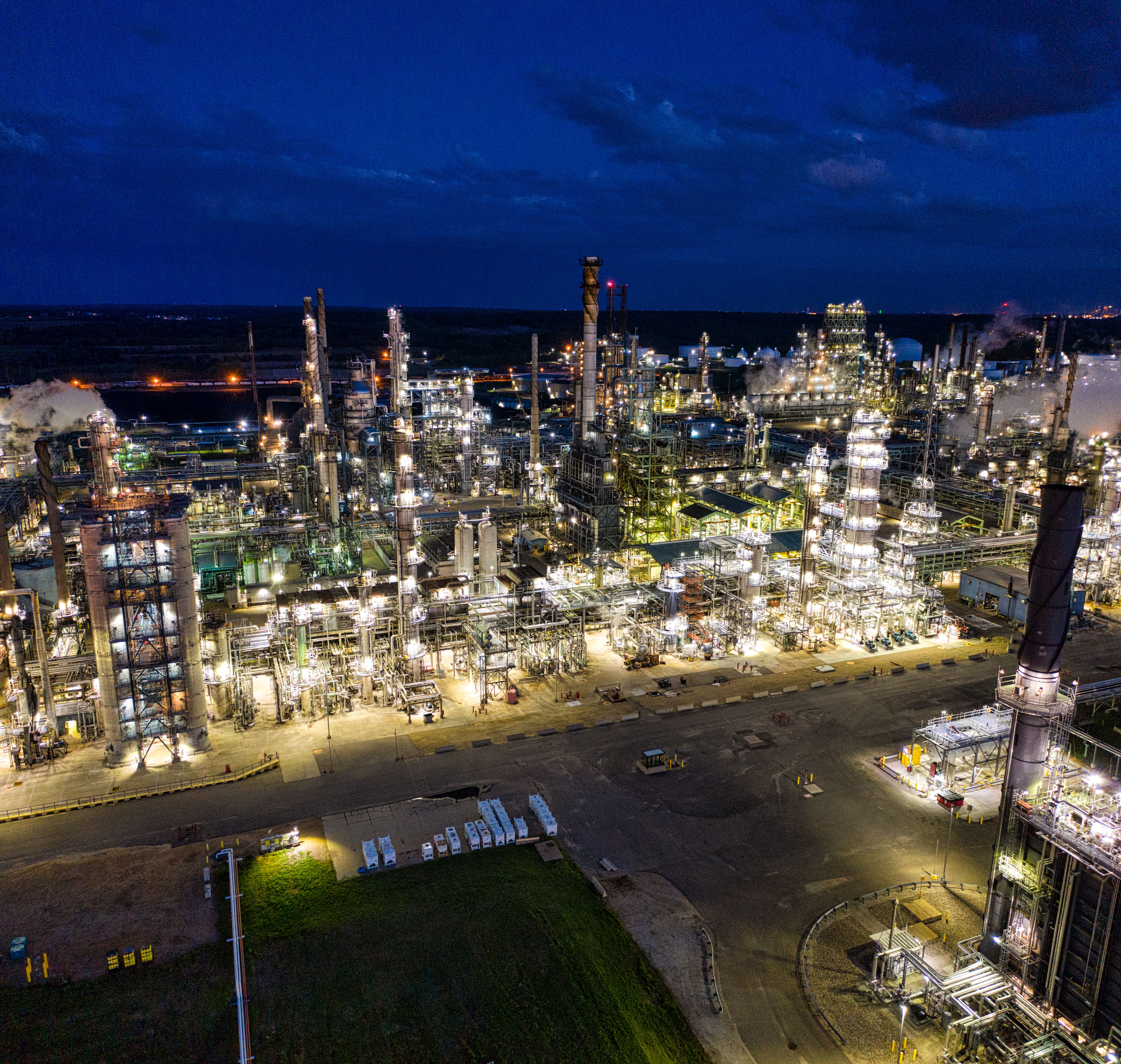 Aerial view of an illuminated oil refinery at night