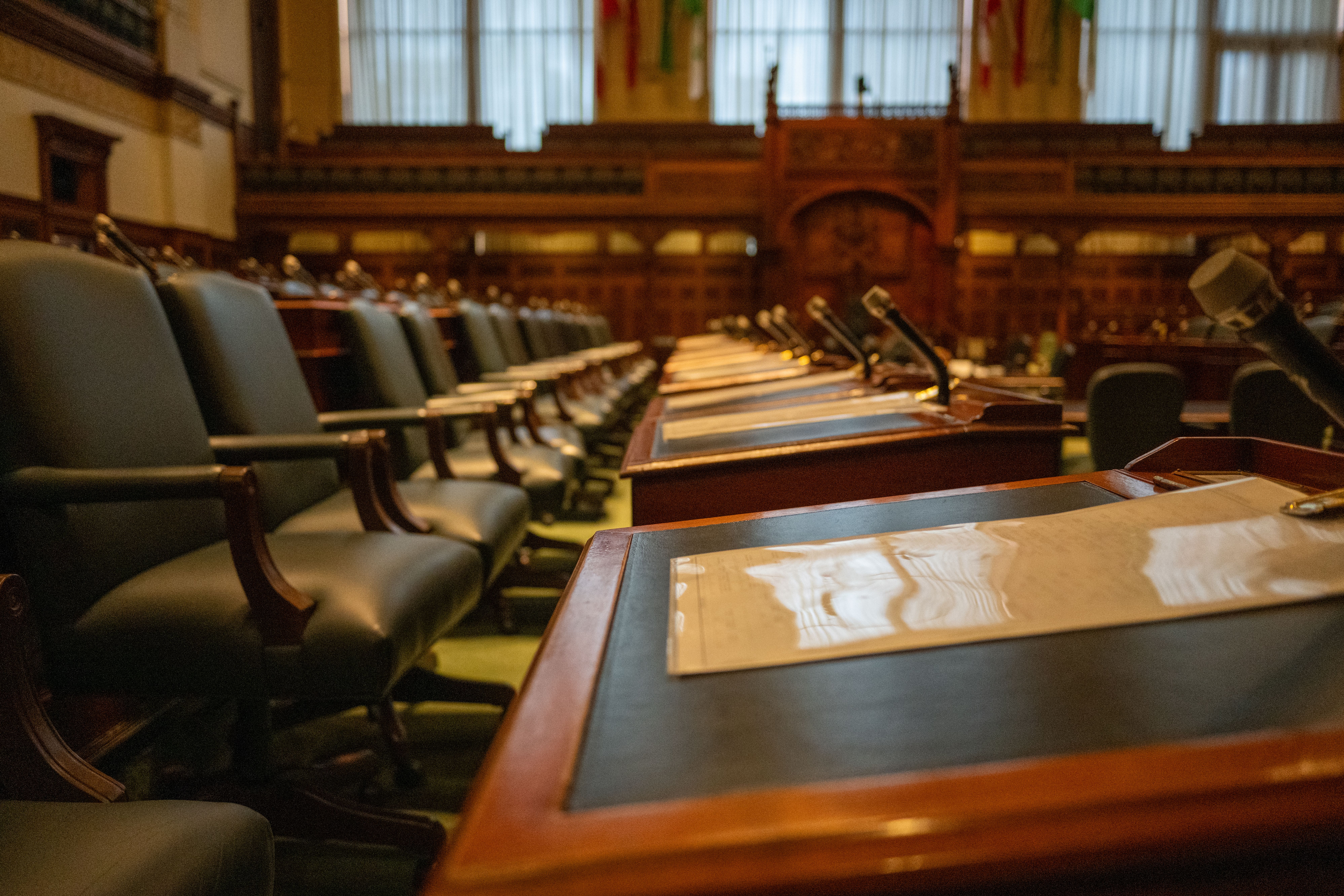 Legislative chamber with rows of desks and microphones