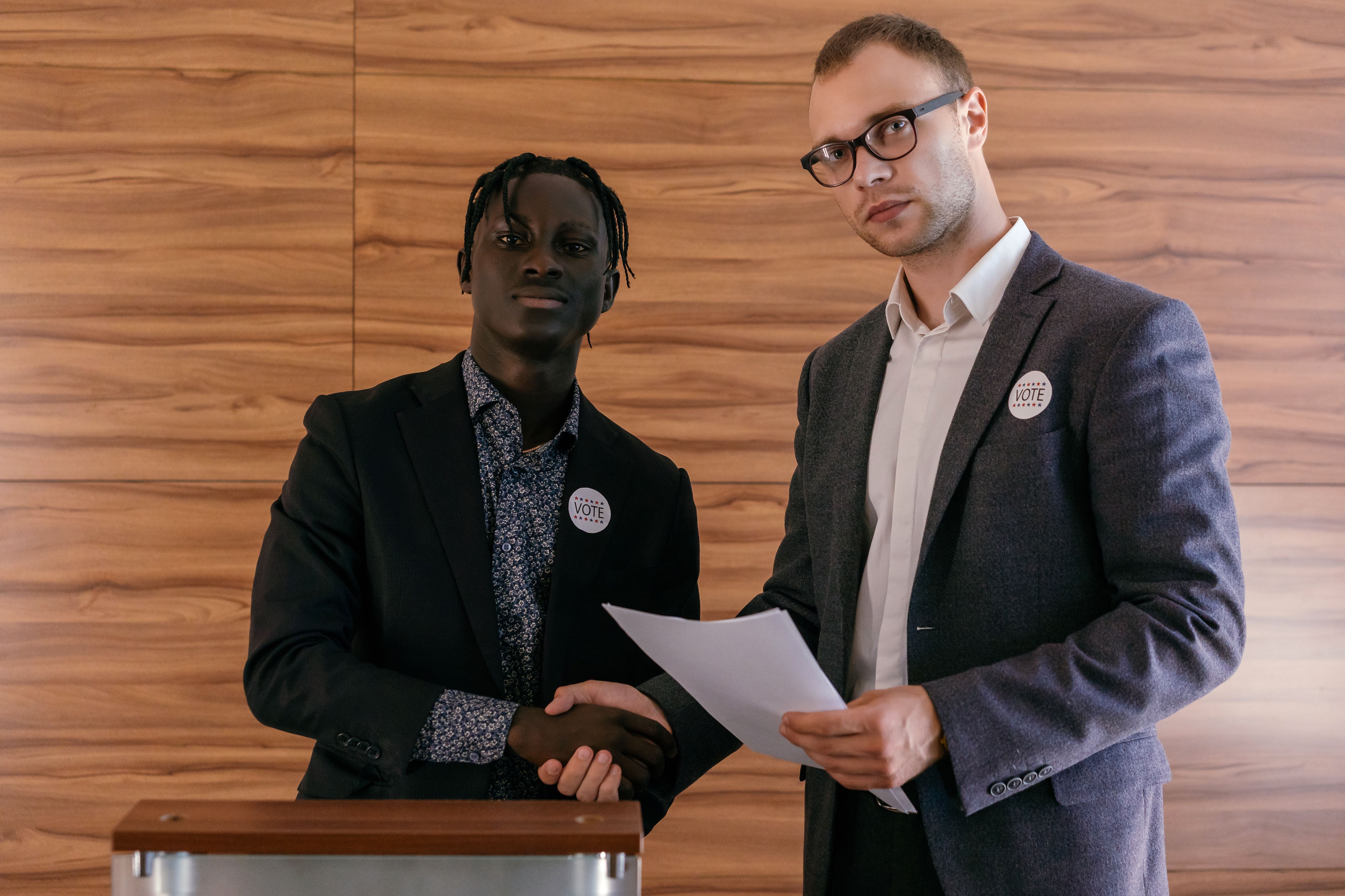 Two officials shaking hands to seal a political appointment